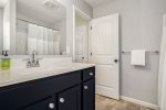 Hall bathroom with a shower tub combo and large vanity 
